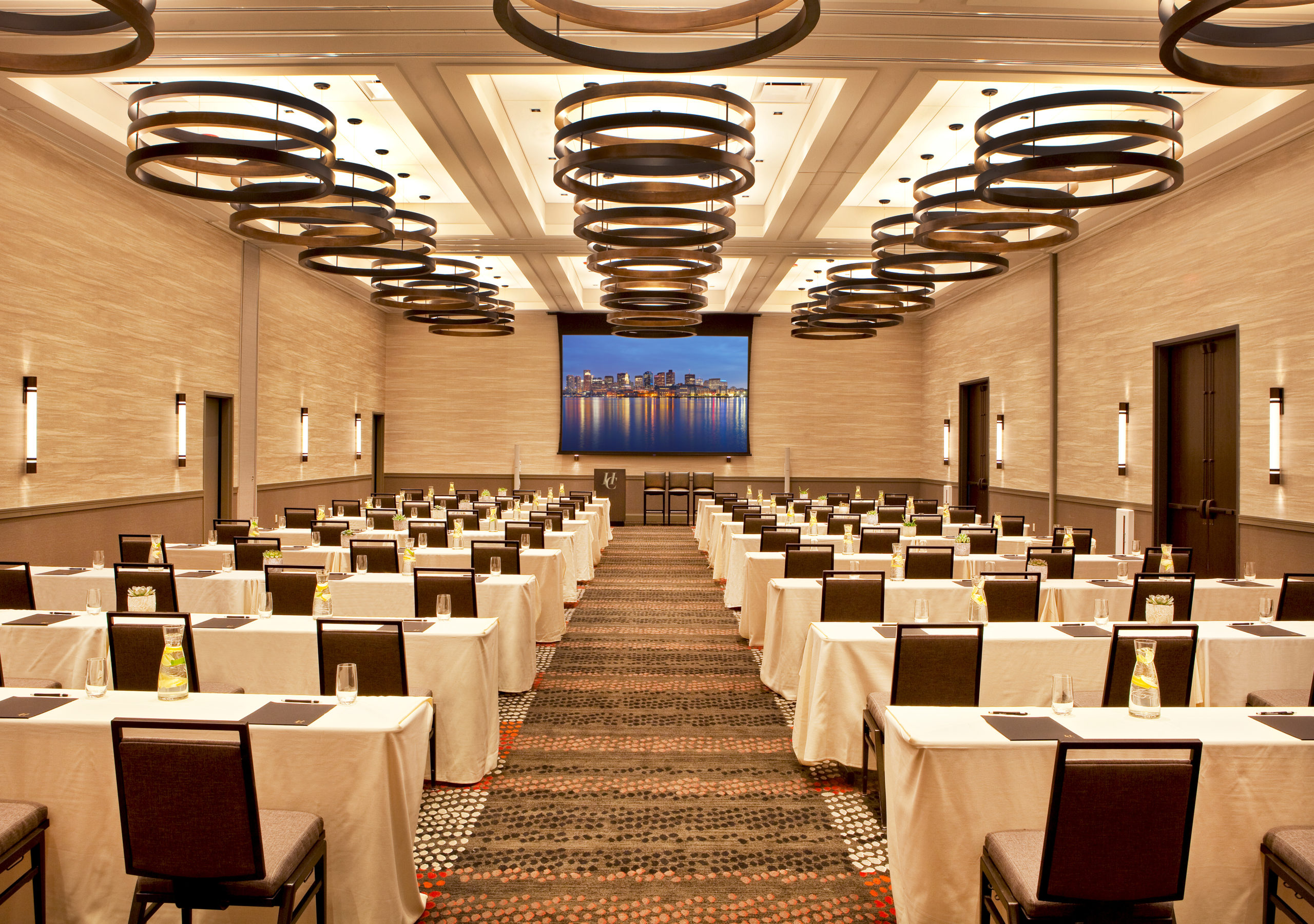 Windowless hotel meeting room setup for a business conference