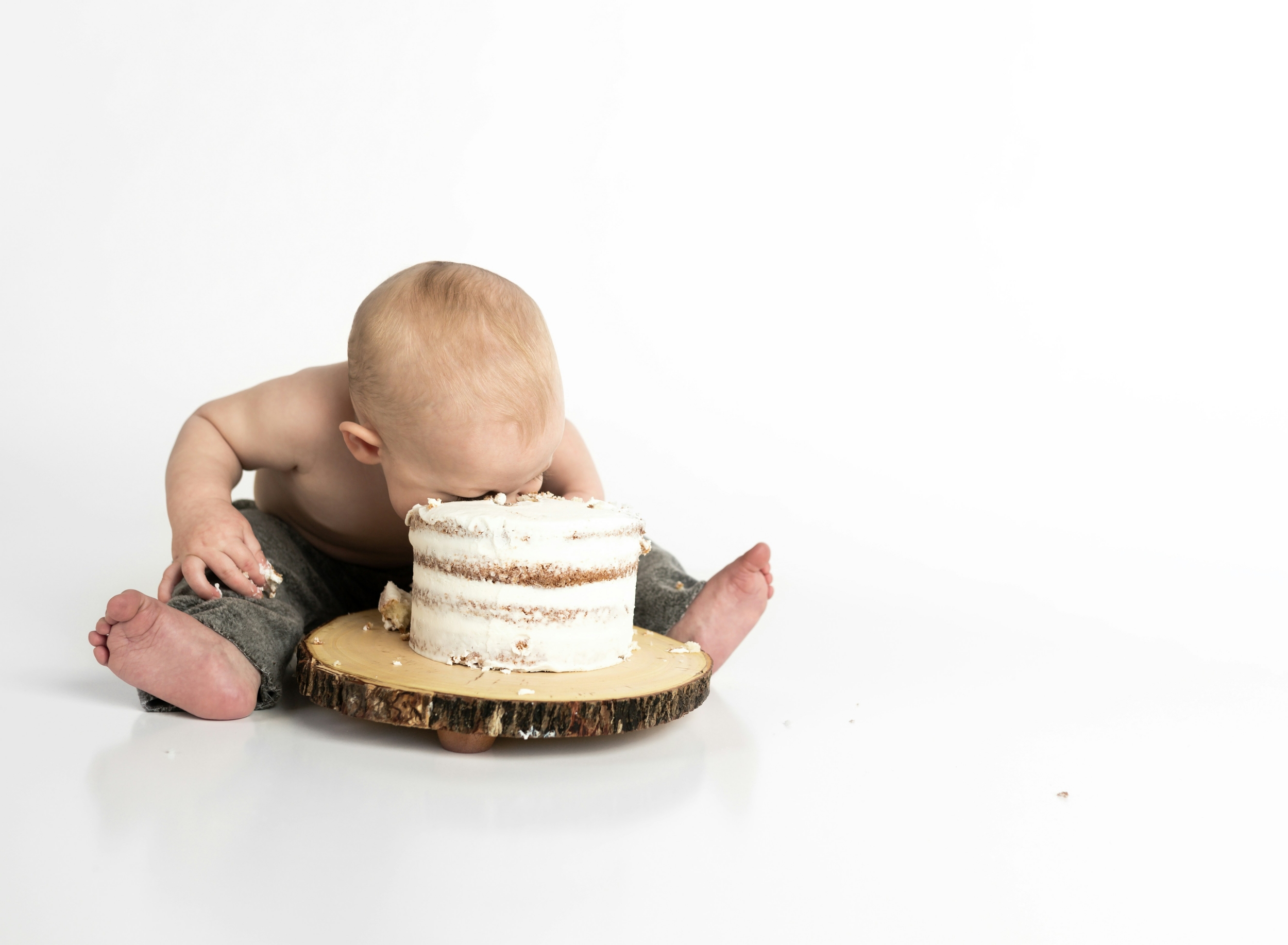 Baby with his face in a cake